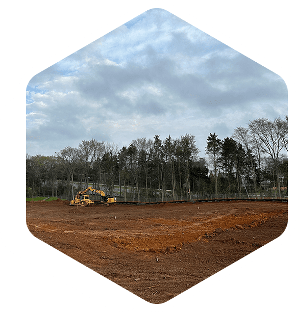 A tractor is parked in the middle of a field.